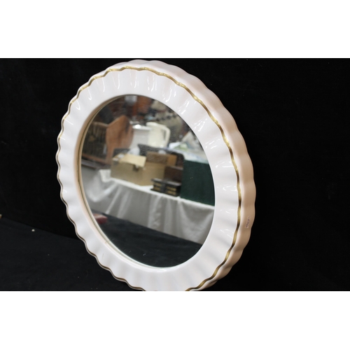 349 - A circular ceramic framed mirror - 49cmD