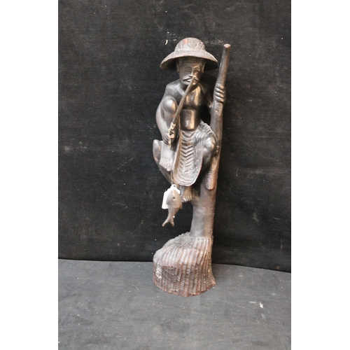 350 - A Sri Lankan/Ceylon hardwood carving of a fisherman - 59cmH