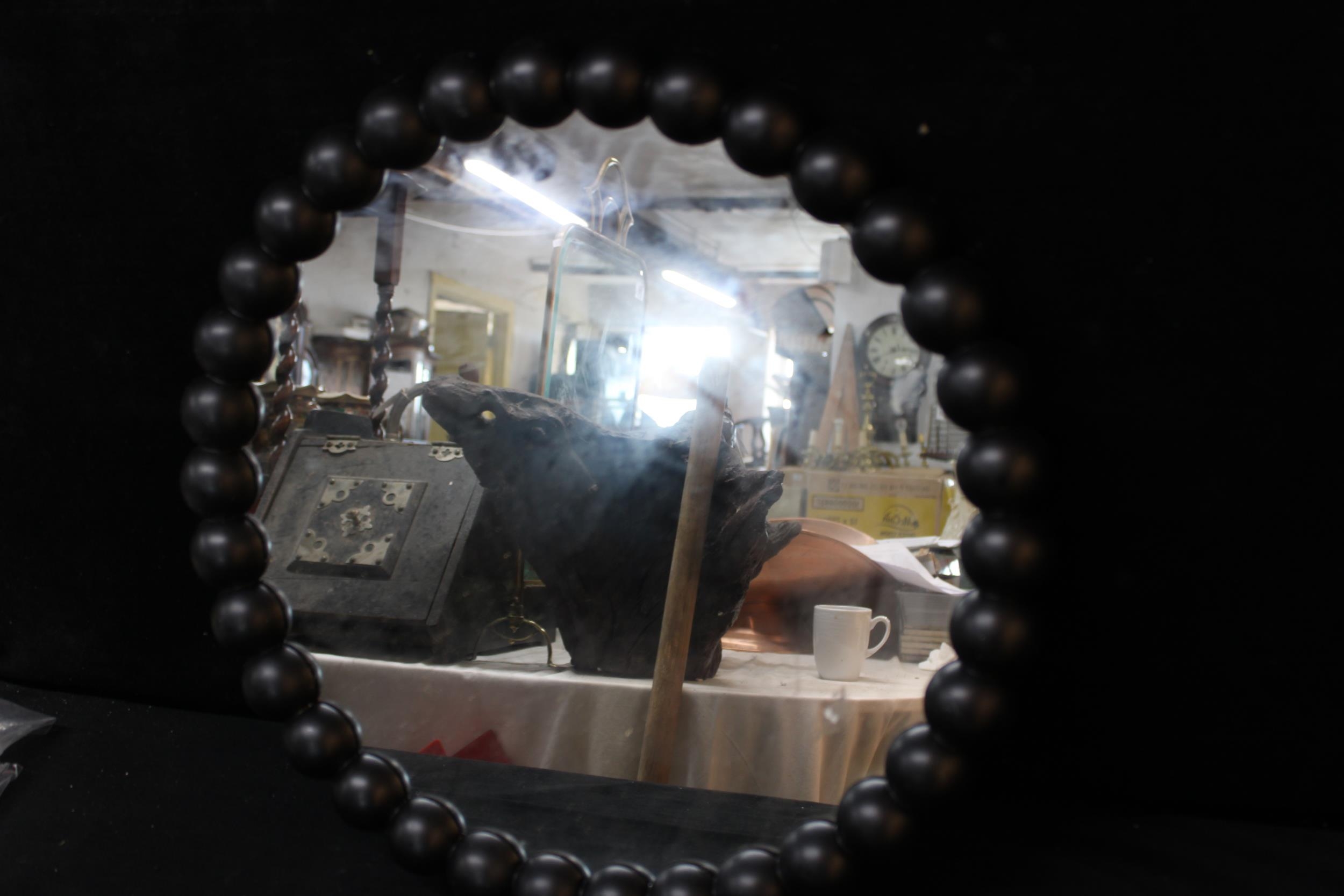 A circular framed wall mirror - 50cmD