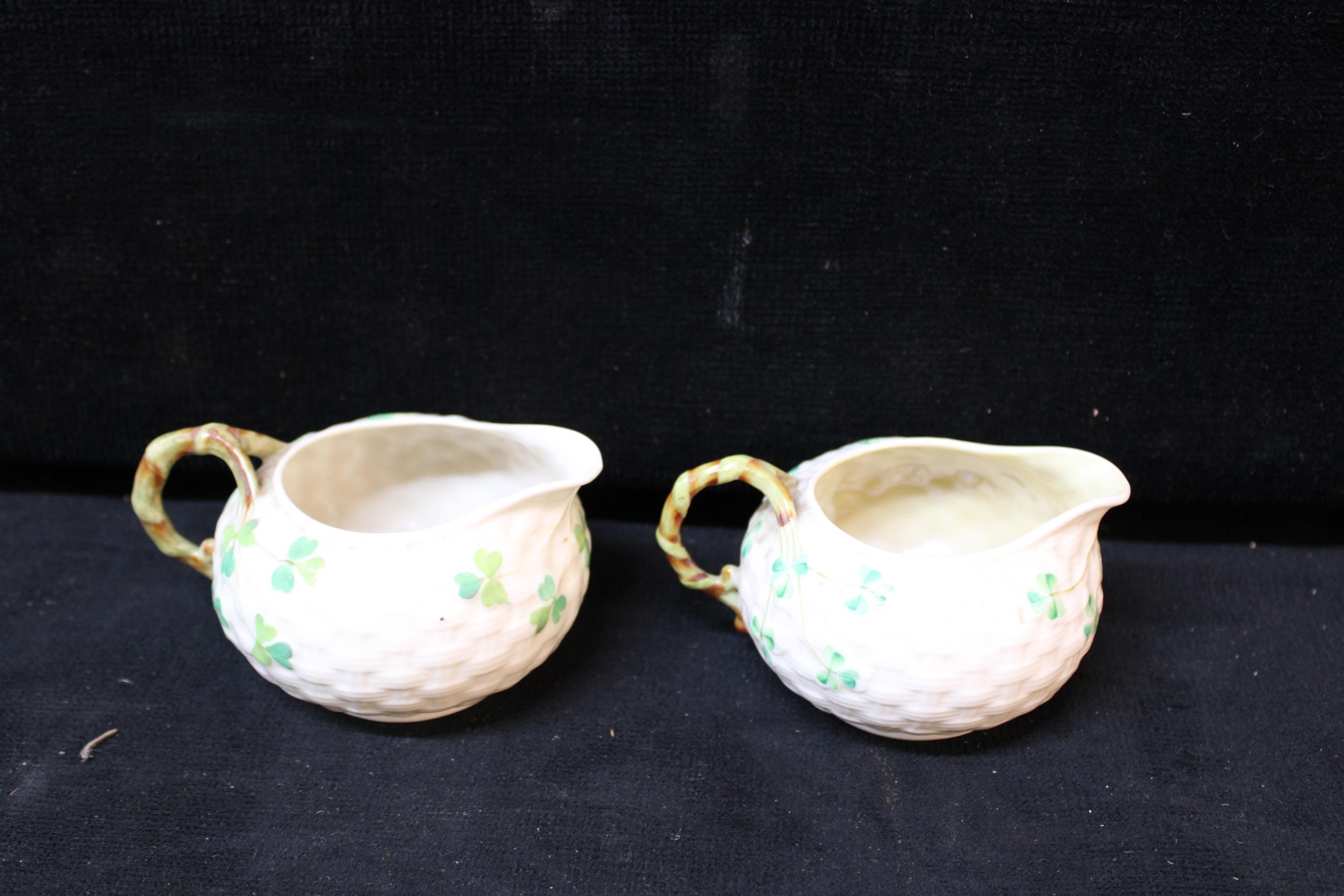Two 3rd period Belleek Parian china jugs, shamrock pattern - 6.5cm largest
