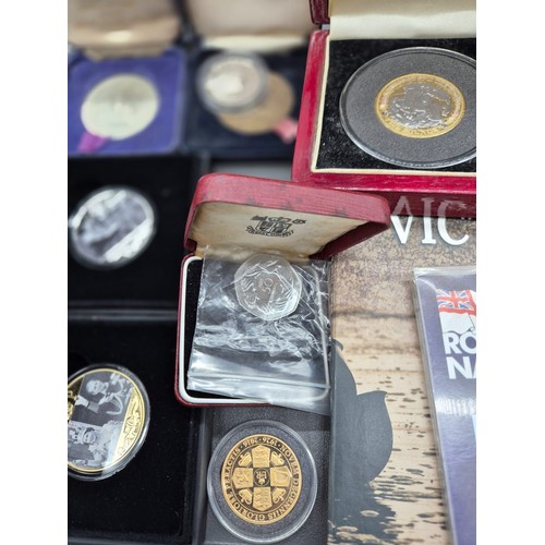 17 - A Collection of boxed mint coins; Royal Naval £5 commemorative coin, The Road to Victory coins and R... 