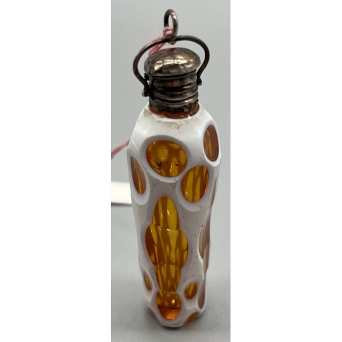 20 - Antique perfume bottle; white single overlay on amber glass, fitted with silver top and has original... 