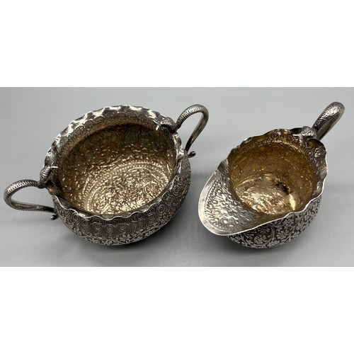 26 - Antique Colonial Indian silver cream jug and sugar bowl, designed with cobra snake handles and raise... 