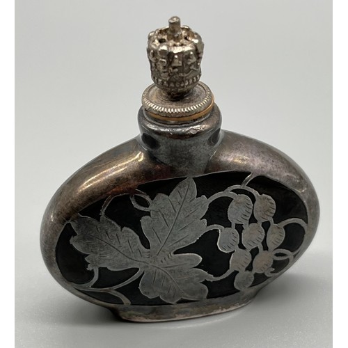 29 - Art Deco perfume bottle with silver overlay, fitted with a crown cap. c1925. [5.5cm high]