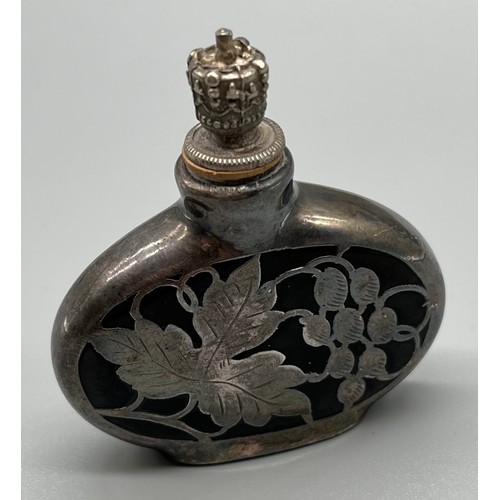 29 - Art Deco perfume bottle with silver overlay, fitted with a crown cap. c1925. [5.5cm high]