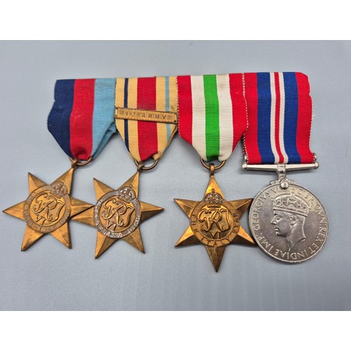 31 - Four bar WWII Medal set; African Star, Italy Star, WWII Star and War medal. 1ST Army Bar Present.