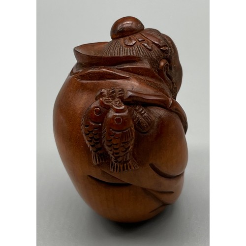 70 - Japanese hand carved netsuke; Cloaked fisherman, Signed to the base. [4.5cm high]