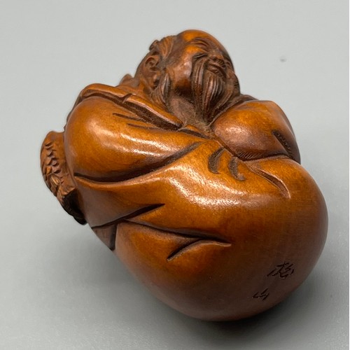 70 - Japanese hand carved netsuke; Cloaked fisherman, Signed to the base. [4.5cm high]