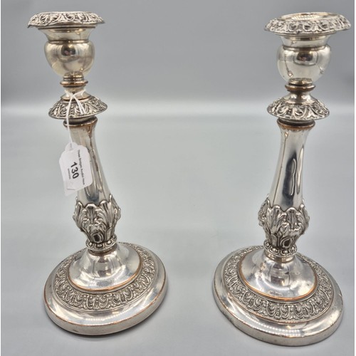 130 - A Pair of 19th century silver plate on copper candle sticks. Raised relief trims. [29cm high]