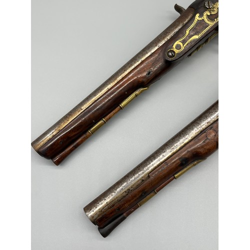145 - A Pair of 18th/ 19th century Percussion Cap duelling pistols. Marked No.9 to each of the brass carto... 