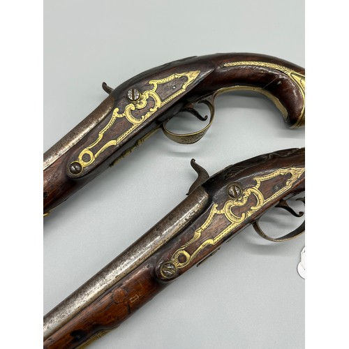 145 - A Pair of 18th/ 19th century Percussion Cap duelling pistols. Marked No.9 to each of the brass carto... 