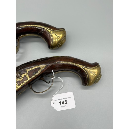 145 - A Pair of 18th/ 19th century Percussion Cap duelling pistols. Marked No.9 to each of the brass carto... 
