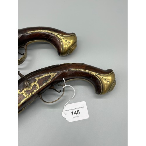 145 - A Pair of 18th/ 19th century Percussion Cap duelling pistols. Marked No.9 to each of the brass carto... 