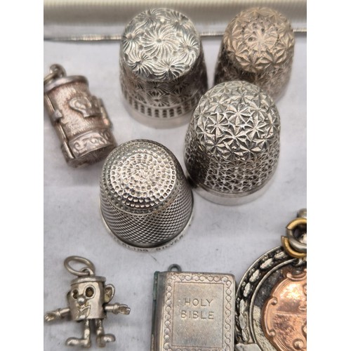 219 - A Selection of silver marked items; Two silver thimbles, Two white metal, Two Silver fob medals, Thr... 