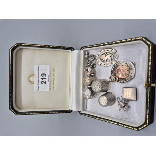 219 - A Selection of silver marked items; Two silver thimbles, Two white metal, Two Silver fob medals, Thr... 