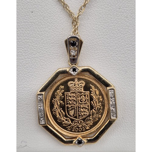 62 - A 2002 Half sovereign in a 9ct yellow gold mount formed as a pendant, with white & black diamonds, t... 