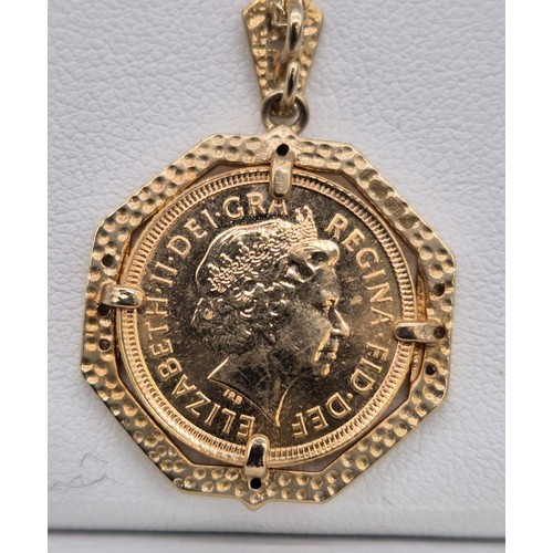 62 - A 2002 Half sovereign in a 9ct yellow gold mount formed as a pendant, with white & black diamonds, t... 