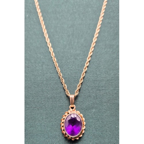 8 - 9ct yellow gold and purple Amethyst pendant, together with a 9ct yellow gold chain. [3.94grams]