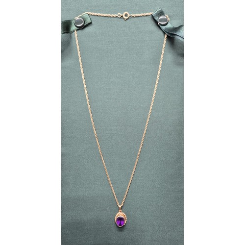 8 - 9ct yellow gold and purple Amethyst pendant, together with a 9ct yellow gold chain. [3.94grams]