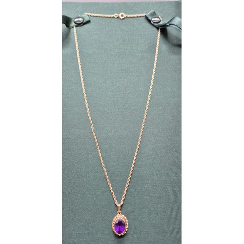 8 - 9ct yellow gold and purple Amethyst pendant, together with a 9ct yellow gold chain. [3.94grams]