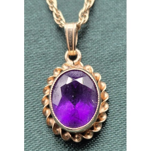 8 - 9ct yellow gold and purple Amethyst pendant, together with a 9ct yellow gold chain. [3.94grams]