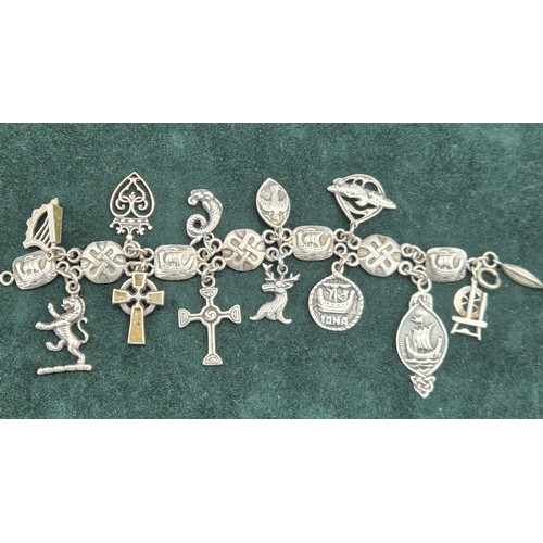 26 - Silver Iona Celtic design charm bracelet; John Hart and Iain MacCormick. 13 charms.