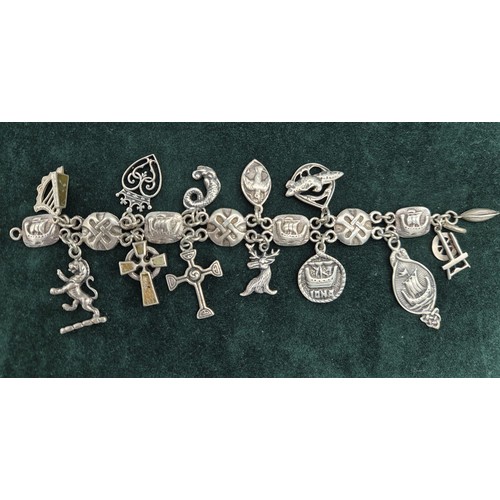 26 - Silver Iona Celtic design charm bracelet; John Hart and Iain MacCormick. 13 charms.