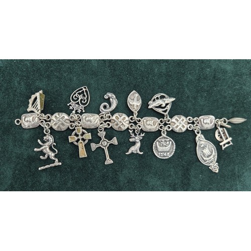 26 - Silver Iona Celtic design charm bracelet; John Hart and Iain MacCormick. 13 charms.