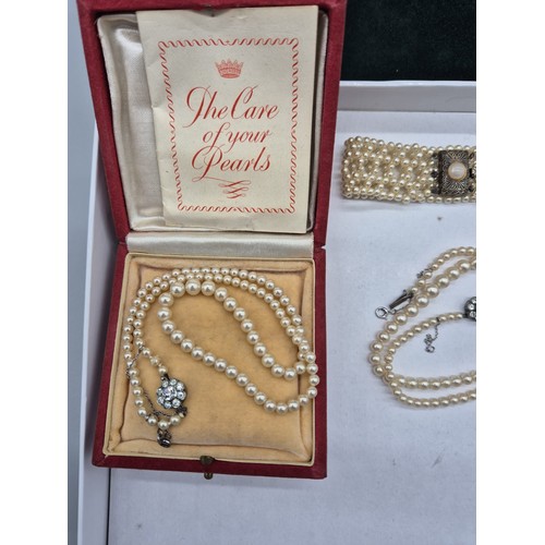 38 - Three items of faux pearl jewellery; Silver and pearl bracelet and two necklaces.