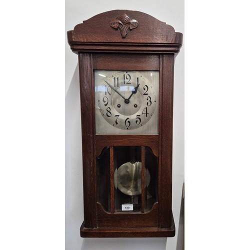 180 - Antique wall clock. Dark oak casing. In a working condition. [82cm high]