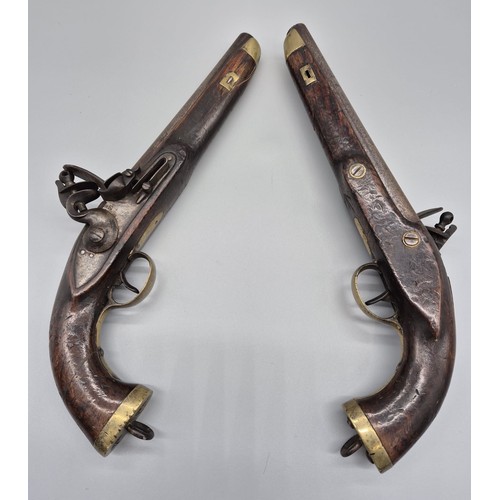 183 - A Pair of 19th century East Indian Company flint lock pistols. Mahogany bodies, Steel and brass fitm... 