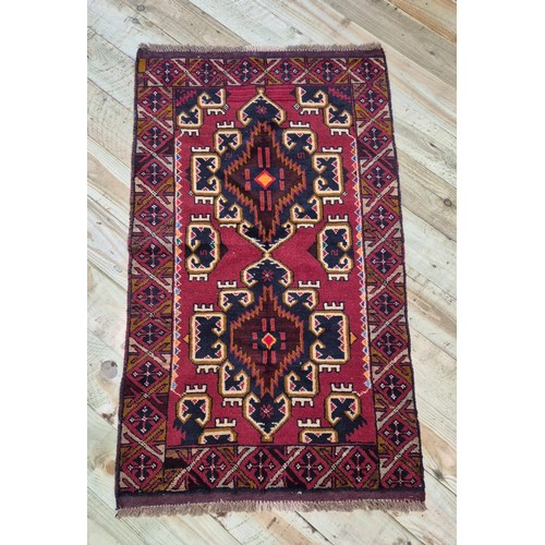 340 - Hand made Baluchi red ground rug. [146x83cm]