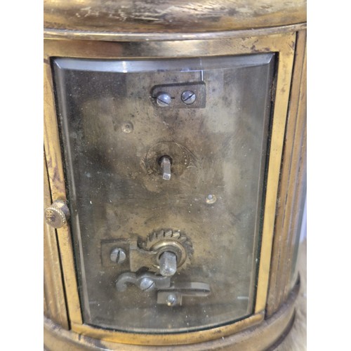 390 - Antique French single barrel brass and bevel glass carriage clock. Comes with leather travel case.