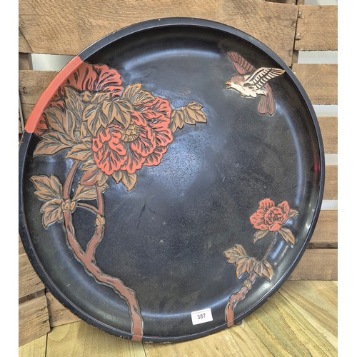 387 - A Large Chinese lacquered, painted and hand carved wooden wall charger. [52.5cm diameter]