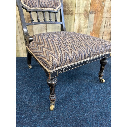 346 - Edwardian ebonised nursing chair. pad back and cushioned area. Raised on turned shaped legs and bras... 