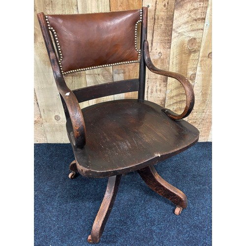 489 - Antique oak and leather captains chair.