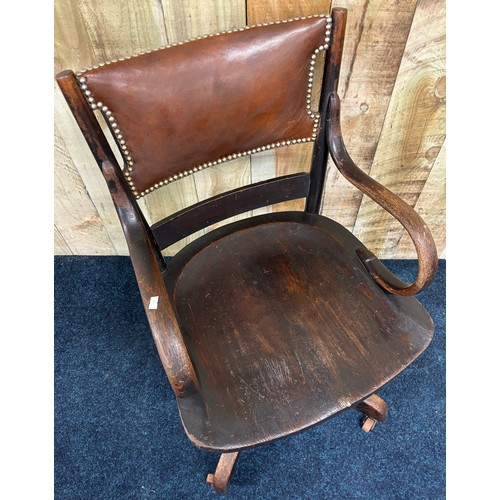 489 - Antique oak and leather captains chair.