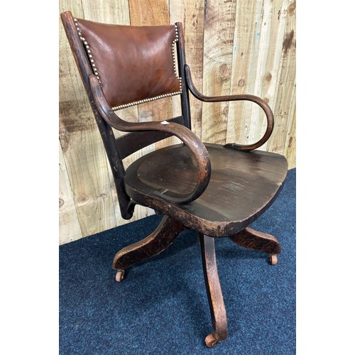 489 - Antique oak and leather captains chair.