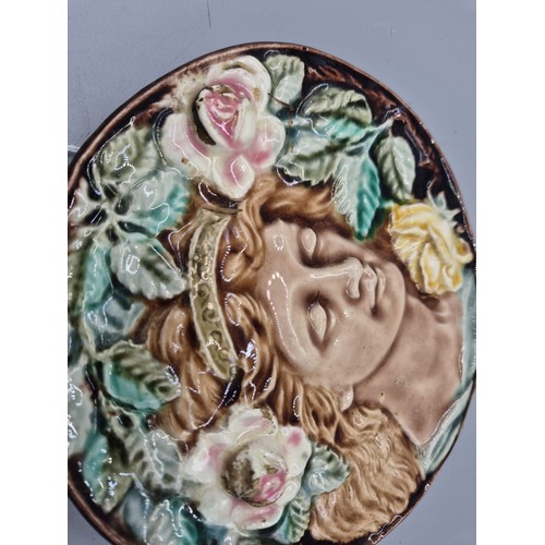 443 - Antique Majolica wall plaque of circle form depicting a portrait of a woman surrounded by roses and ... 