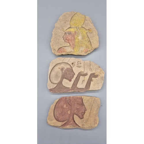 436 - Three carved Egyptian sandstone pieces with Ancient Egyptian designs. [Large piece- 24x23cm]