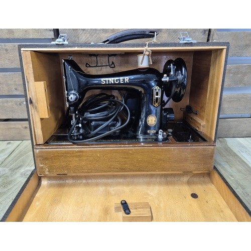 432 - Cased electric 99K Singer sewing machine.