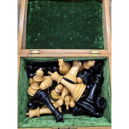 408 - Antique light oak box containing turned chess pieces. [10.5cm high- tallest piece]