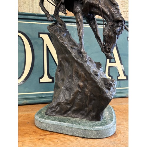 406 - After Frederic Remington 
Limited edition 24/100 patinated bronze on green marble plinth titled 