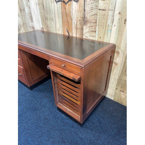 349 - 1909 Bankers/ Partners desk. Solid mahogany with composite top. Lift up side door revealing eight na... 