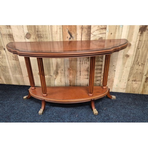 318 - Reproduction mahogany half moon console, raised on column supports with outswept legs leading to bra... 