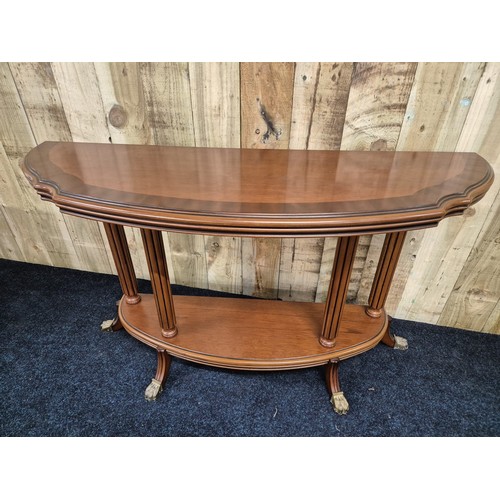 318 - Reproduction mahogany half moon console, raised on column supports with outswept legs leading to bra... 