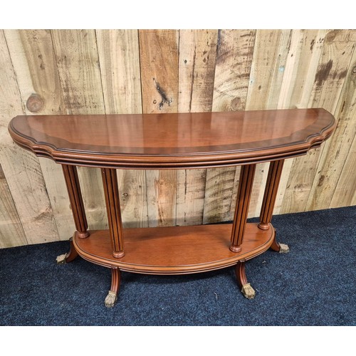 318 - Reproduction mahogany half moon console, raised on column supports with outswept legs leading to bra... 