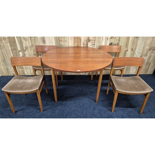 315 - Mid century Beatility dining table of round form with four matching chairs.