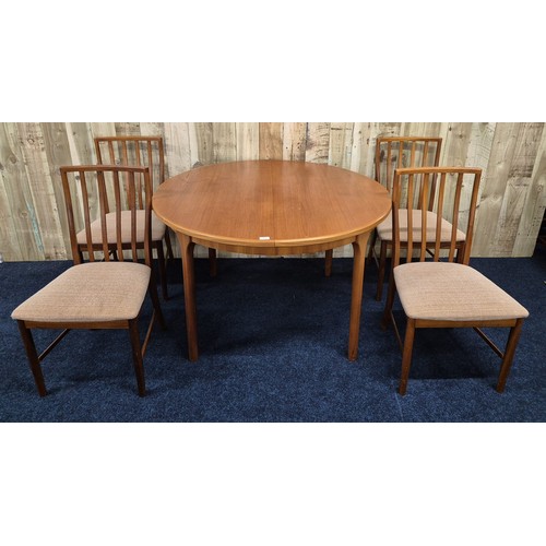 314 - Mid century teak fold out dining table of round form, together with four matching chairs- Produced b... 