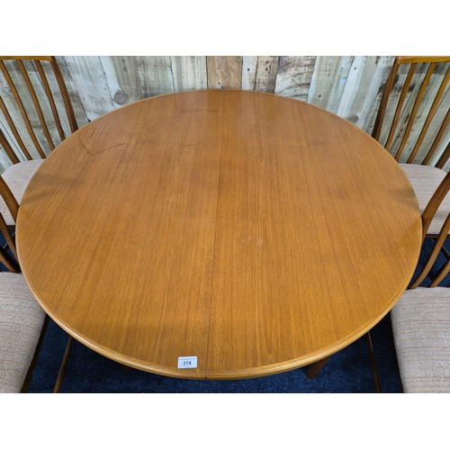 314 - Mid century teak fold out dining table of round form, together with four matching chairs- Produced b... 